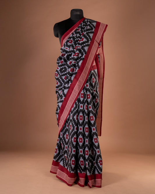 Bold Elegance in Every Drape - Handwoven Black Ikat Saree with Striking Red Accents